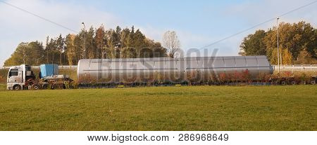 Oversize Load Or Exceptional Convoy. A Truck With A Special Semi-trailer For Transporting Oversized 