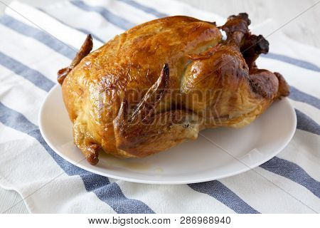 Homemade Traditional Rotisserie Chicken On White Plate, Side View. Close-up.