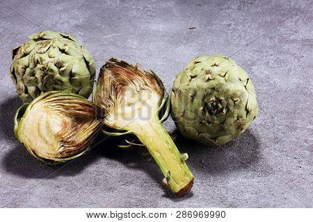 Artichokes On Rustic Background. Fresh Organic Artichoke Flower Set