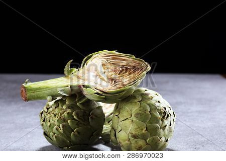 Artichokes On Rustic Background. Fresh Organic Artichoke Flower Set