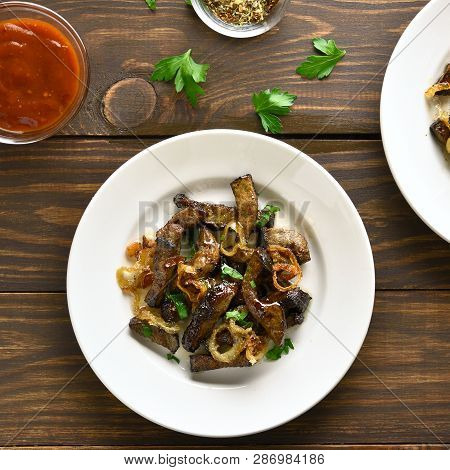 Fried Beef Liver With Onion On Plate Over Wooden Background. Pieces Cooked Liver (offal) From Beef. 