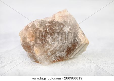 Natural Mineral - Polychrome Fluorite From Transbaikalia, Russia On White Cement Background.