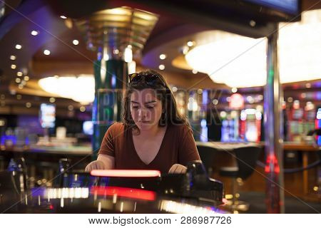 Woman Playing Slot Machines At The Casino