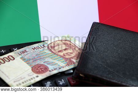 One Thousand Lire Of Italy Banknote With Black Wallet On The Calculator With Italia Flag Background,