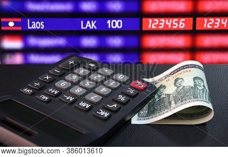 One Thousand Of Banknote Currency Lao Kip With Calculator On The Black Floor With Digital Board Of C