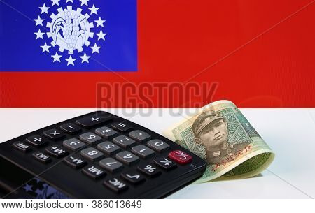 One Of Banknote Currency Myanmar Kyats With Calculator On The White Floor With The Obsolete Flag Of 