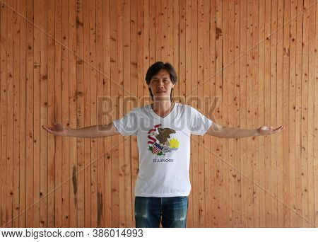 Man Wearing Illinois Flag Shirt And Standing With Arms Wide Open On The Wooden Wall Background, Seal