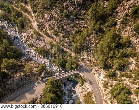 Road And Bridge Over Mountain Stream In Corsica