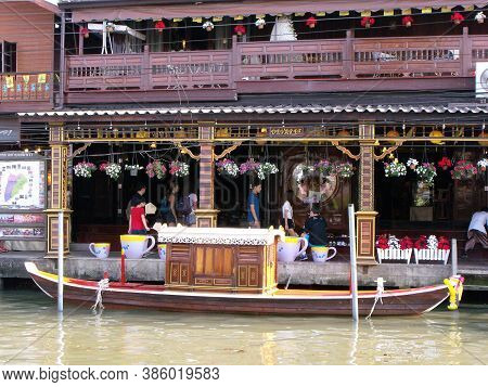 Amphawa, Thailand, January 23, 2016: People Stroll Along The Edge Of The Canal At Amphawa Floating M