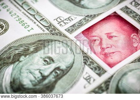 Yuan Banknote, Surrounded By 100 Dollar Bills. American Market Protectionism Concept