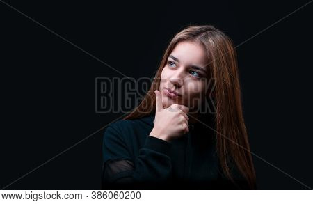 Thoughtful Model In Studio Looking Away. Hand Near The Face