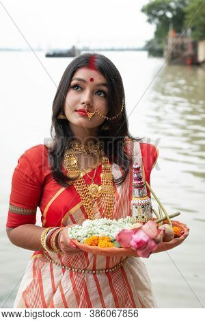 Portrait Of Beautiful Indian Girl Wearing Traditional Indian Saree, Gold Jewellery And Bangles Holdi