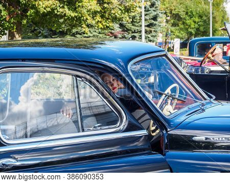 New Torial, Russia - September 12, 2020: Black Gaz 12 Zim At The Retro Car Show. Young Woman Posing 