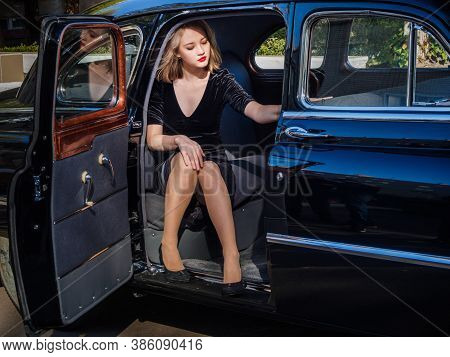 New Torial, Russia - September 12, 2020: Black Gaz 12 Zim At The Retro Car Show. Young Woman Posing 