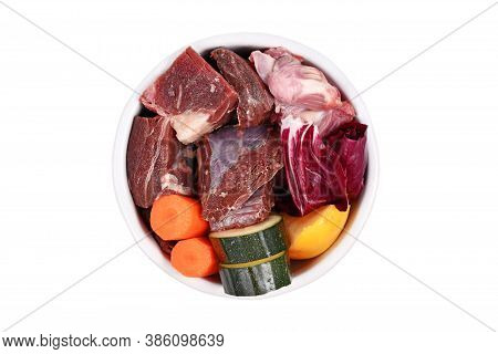 Bowl With Species Appropriated Raw Food For Dogs Like Chunks Of Meat, Chicken Stomache And Vegetabls