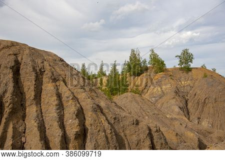 Relief Clay Mountains Under A Cloudy Sky.