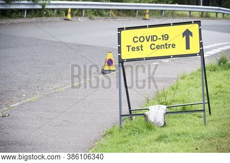 Covid-19 Test Centre Sign At Road With Traffic Cones