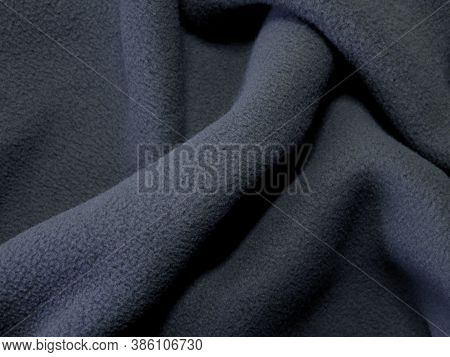 Blanket Made Of Fluffy Fleece Fabric. Background Made Of Soft Plush Fleece Material With Lots Of Rai