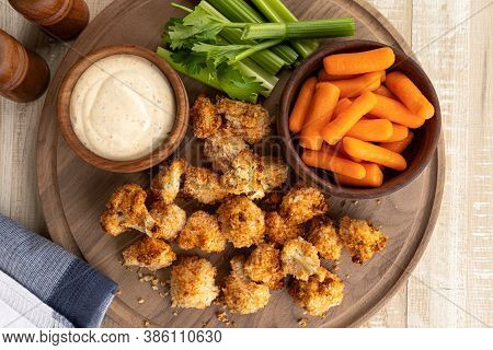 Crispy Air Fried Cauliflower Florets And Ranch Dip With Carrots And Celery On A Wooden Tray.  Overhe