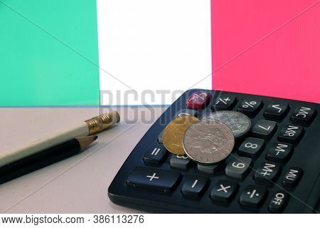 Heap Of Italy Coins On Calculator And Pencil On White Floor With Italia Flag Background, Repvbblica 