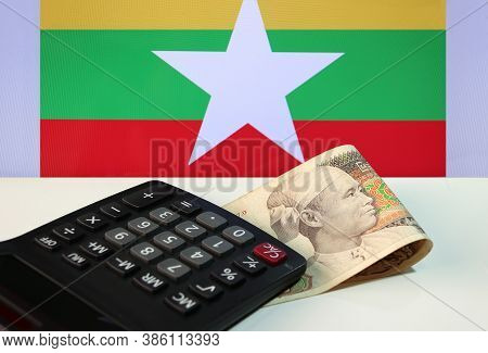 Seventy Five Of Banknote Currency Myanmar Kyats With Calculator On The White Floor With The Union Of
