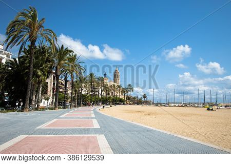 Empty Promenade Passeig De La Ribera With The Views Of Church Sant Bartomeu Y Santa Tecla, Sitges, C