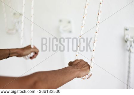 Closeup Hands Holding The Rope, Iyengar Yoga At Studio, White Wall
