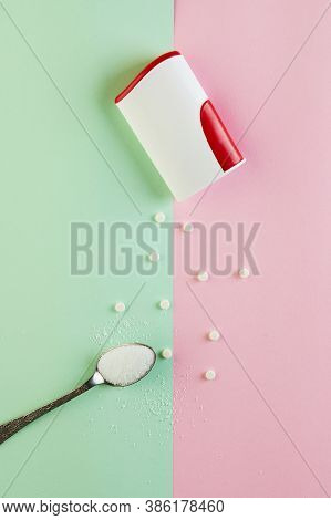 Sugar Substitute Tablets And Natural Sweetener Powder On A Green-pink Background. Flat Lay