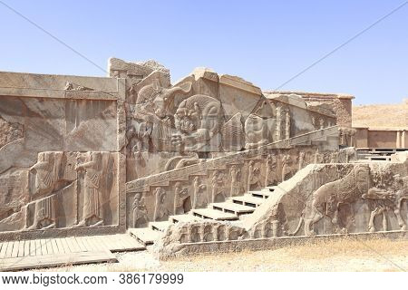 Famous bas-relief on the wall in ancient city Persepolis,  Iran. The lion attacks the bull and bites it (symbolizes fertility of earth and change of seasons of year). UNESCO world heritage site