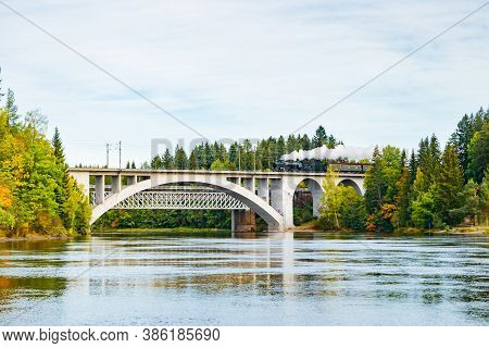 Kouvola, Finland - 18 September 2020: Autumn Landscape Of Bridge With Moving Old Steam Passenger Tra