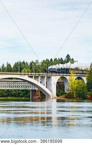 Kouvola, Finland - 18 September 2020: Autumn Landscape Of Bridge With Moving Old Steam Passenger Tra