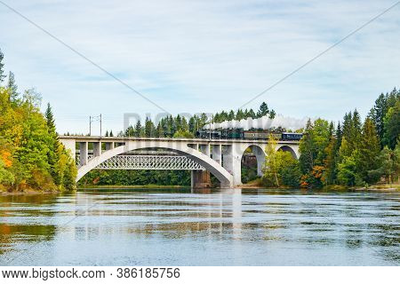 Kouvola, Finland - 18 September 2020: Autumn Landscape Of Bridge With Moving Old Steam Passenger Tra
