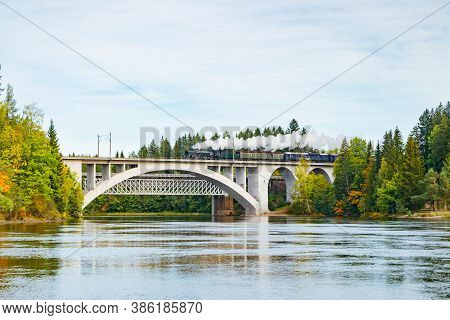 Kouvola, Finland - 18 September 2020: Autumn Landscape Of Bridge With Moving Old Steam Passenger Tra