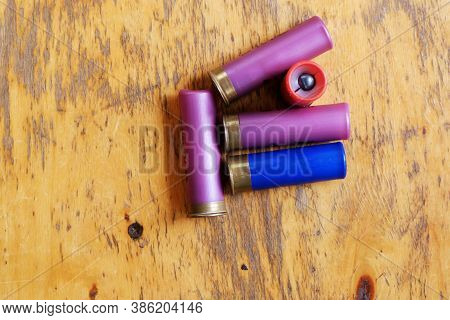 Hunting Cartridges For A Smoothbore Rifle On An Old Wooden Lacquered Table Surface. Selective Focus.
