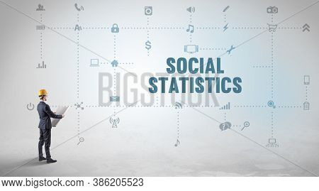 Engineer working on a new social media platform with SOCIAL STATISTICS inscription concept