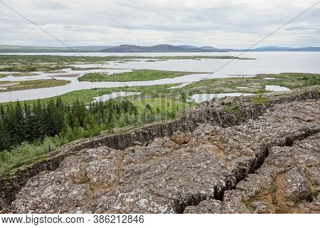Landscape With Rocks, Oxara River And Large Thingvallavatn Lake In Thingvellir, Iceland, Uk In Overc