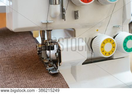 Overlock Sewing Machine In Process. Professional Equipment
