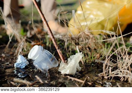 Rubbish Collecting Outdoors In Nature, Plogging Concept.