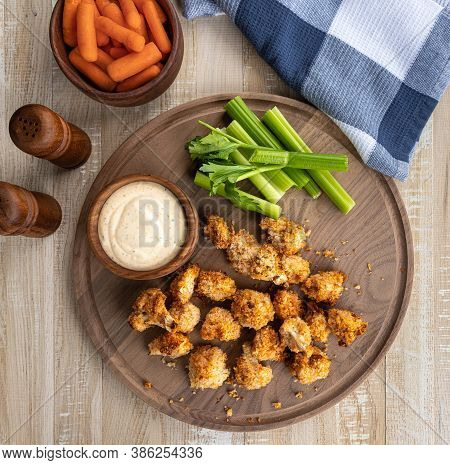 Crispy Air Fried Cauliflower Florets And Ranch Dip With Carrots And Celery On A Wooden Tray.  Overhe