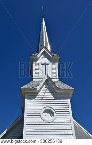 A Beautiful Church Steeple Against A Deep Blue Sky