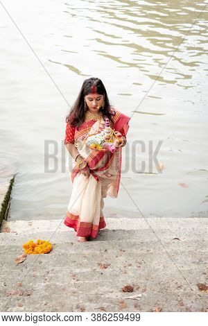 Portrait Of Beautiful Indian Girl Wearing Traditional Indian Saree, Gold Jewellery And Bangles Holdi