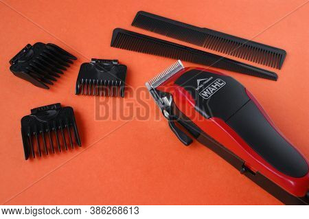 Kharkov, Ukraine - July 2, 2020 : Hairdressers Tool. Hair Clipper Wahl Close-up On A Red Background 