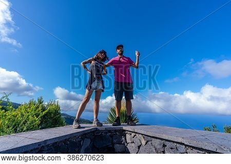A Very Happy Couple On Top Of The Mountain At The Viewpoint Of The Cubo De La Galga Natural Park On 