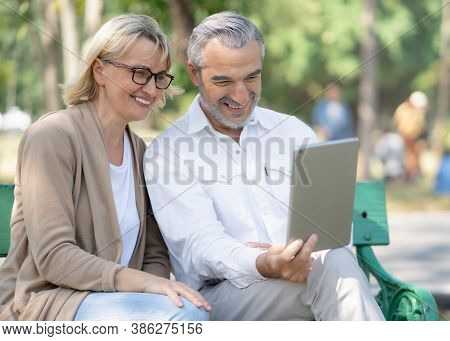 Technology Connect And Modern Elderly Lifestyles Concept. Aged Senior Couple Waving Hands Greeting G
