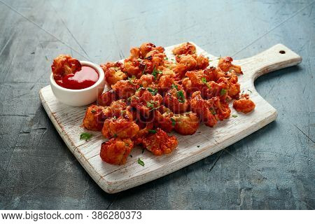 Vegan Cauliflower Buffalo Wings On White Wooden Board