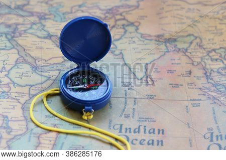 Classic Round Compass On Background Of Old Vintage Map Of World As Symbol Of Tourism With Map And Co