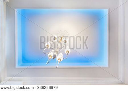 Suspended Ceiling With Neon Spots Lamps And Drywall Construction In Empty Room In Apartment Or House