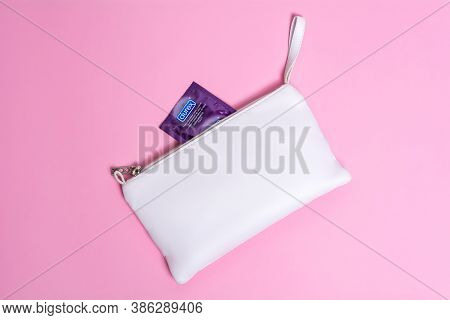 Kyiv, Ukraine - 14 July 2020: Durex  Elite Condom Near White Cosmetic Bag. Health And Safe Sex