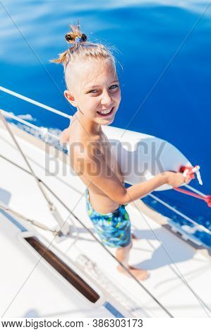 Little Boy On Board Of Sailing Yacht On Summer Cruise. Travel Adventure, Yachting With Child On Fami