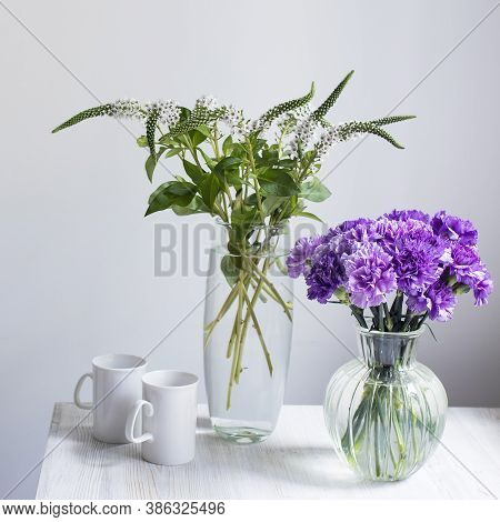 Bridal Bouquets Of Lilac Carnations In A Four Round Glass Vases Different Sizes As Table Decoration.
